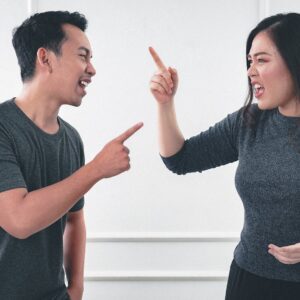 A Man and Woman Arguing while Pointing Fingers